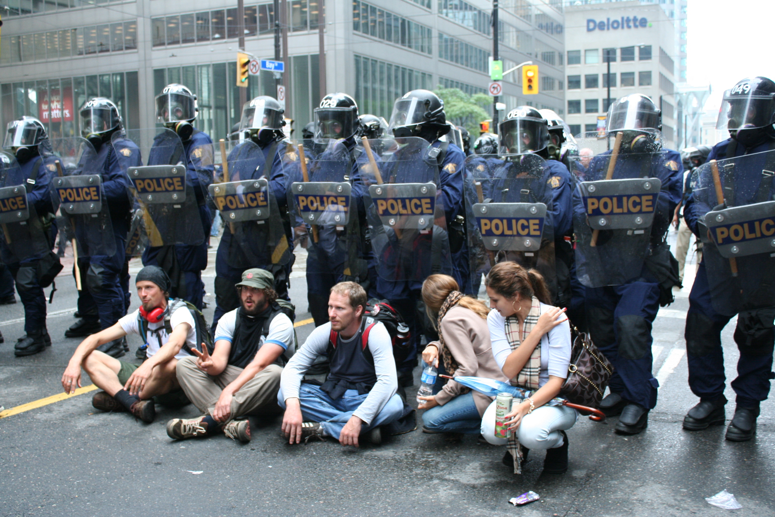 G20 protesters in Toronto sit in front of a line of riot police