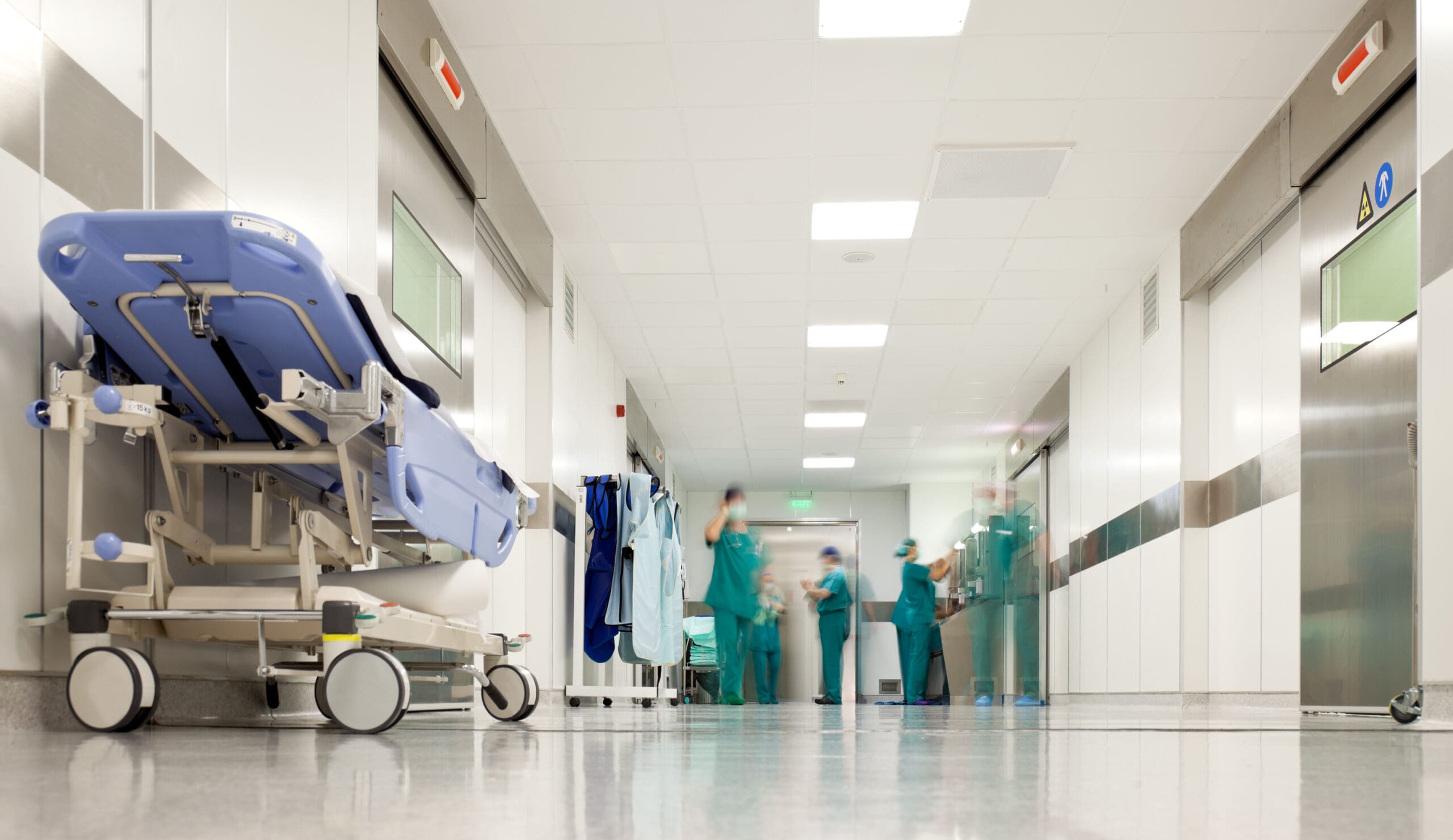 Hospital surgery corridor. Blurred figures of people with medical uniforms in hospital corridor