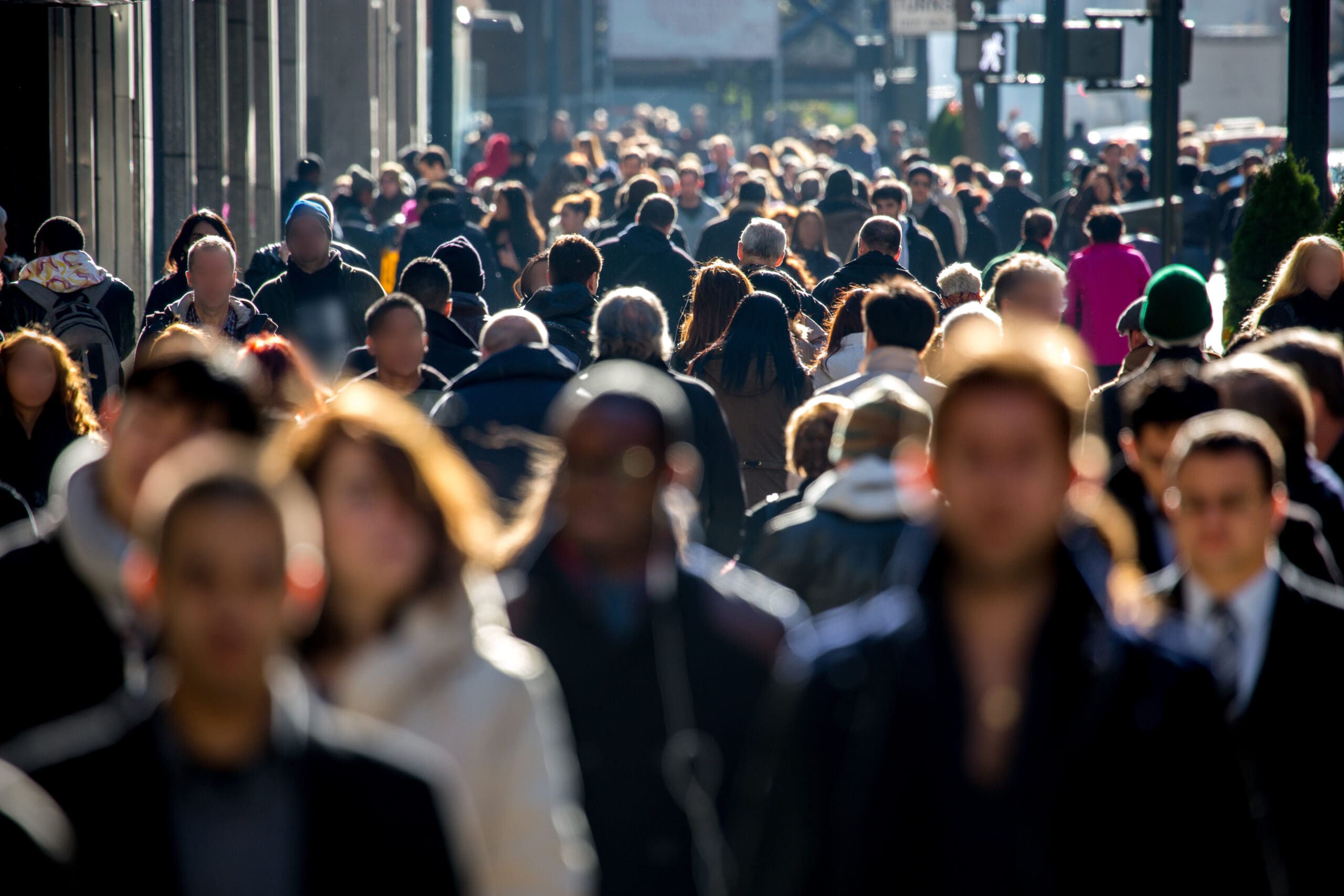 Anonymous crowd of people walking on city street