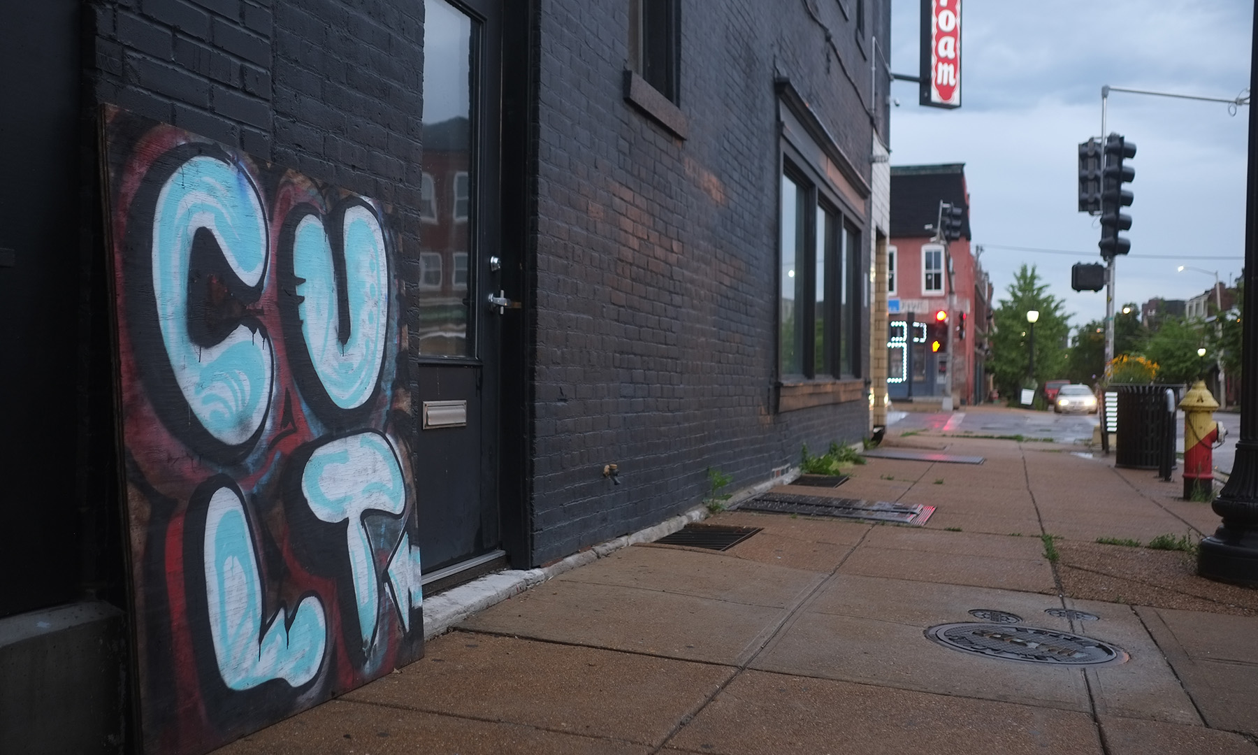 black brick wall with graffiti spelling Cult